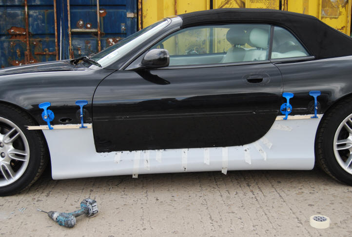Jaguar side skirts being bonded to an XK8 convertible